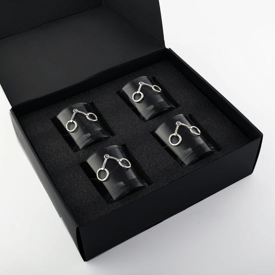 The set of four equestrian bit bar glasses displayed in their stylish black presentation gift box.