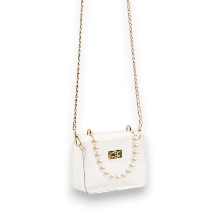 An alternate view of the clear stadium bag showcasing both the pearl wristlet and the long gold chain strap.
