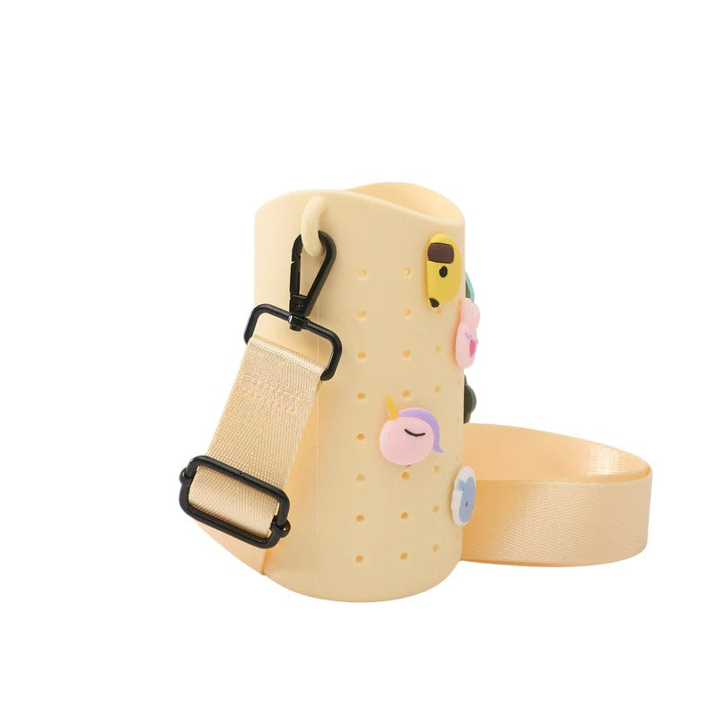 A close-up of the adjustable strap and charms included with the yellow Bestie Sling
