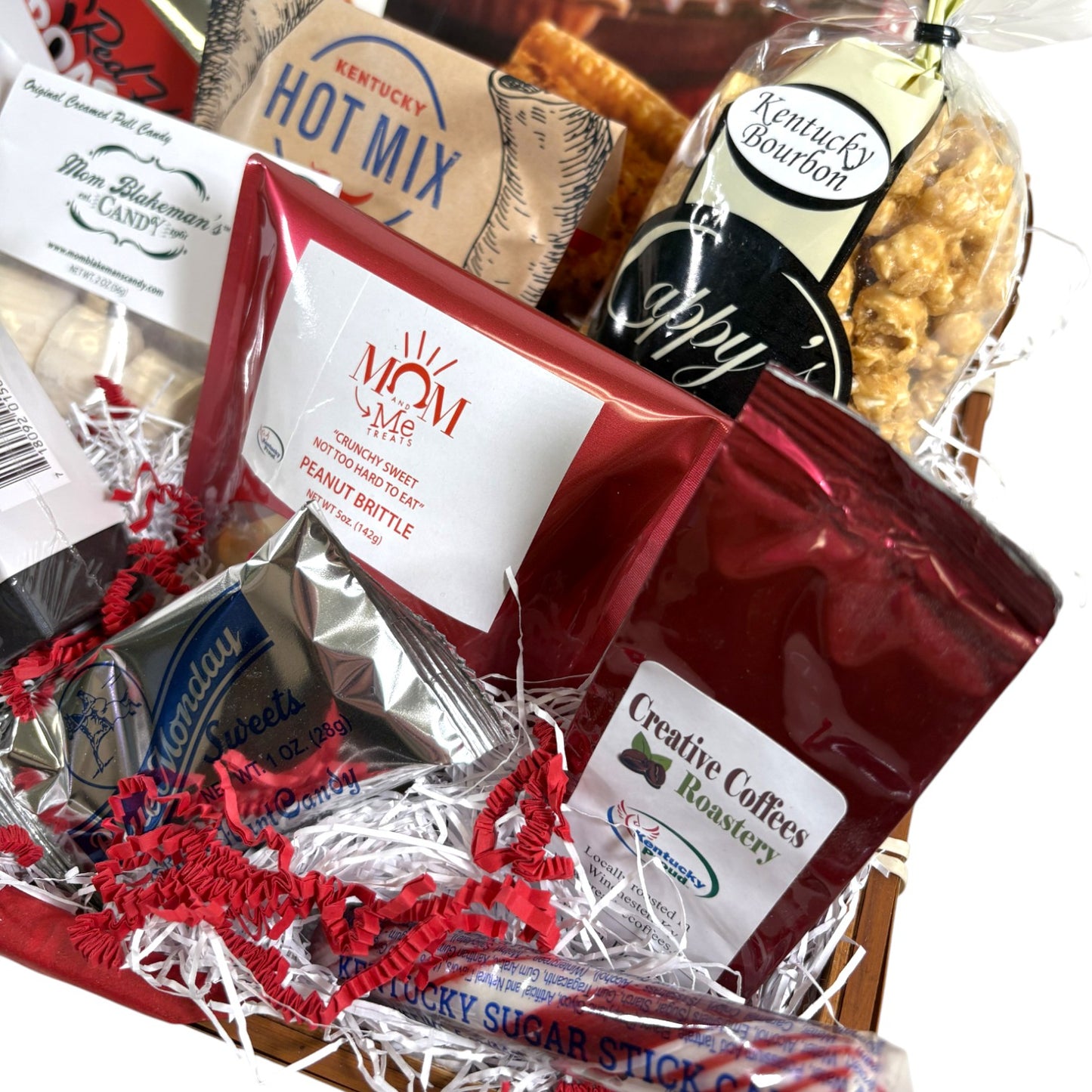 Assorted gift items including a bag of Mom's Candy Brittle and a bag of Creative Coffees Roastery coffee.