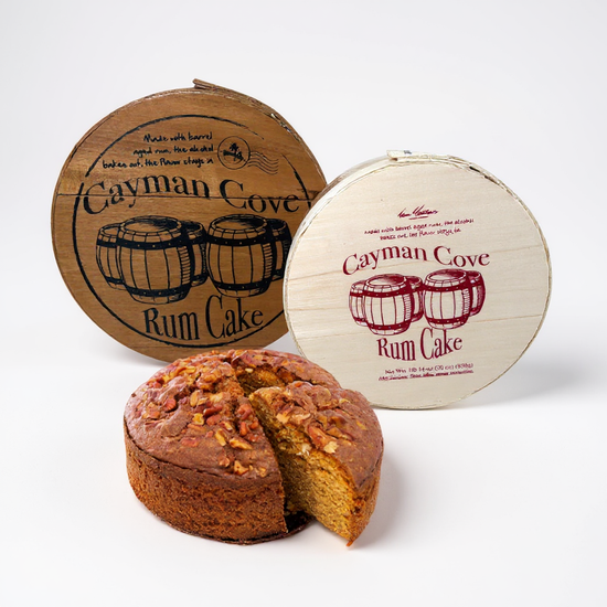 Cayman Cove Rum Cake with two wooden packaging containers on a white background