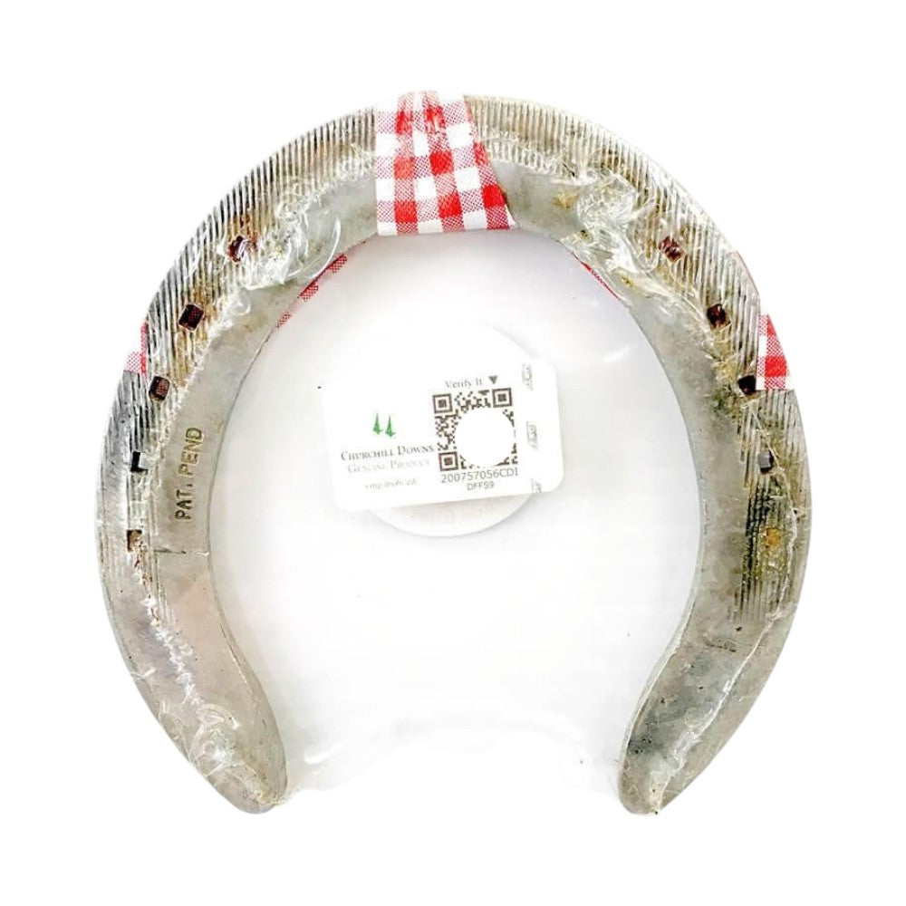 Decorative horseshoe with a white ball inside, on a white background
