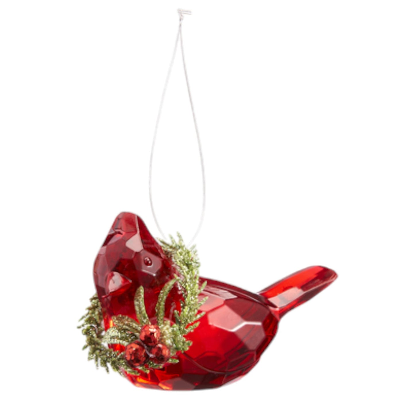 Red glass bird ornament with greenery and berries on a white background