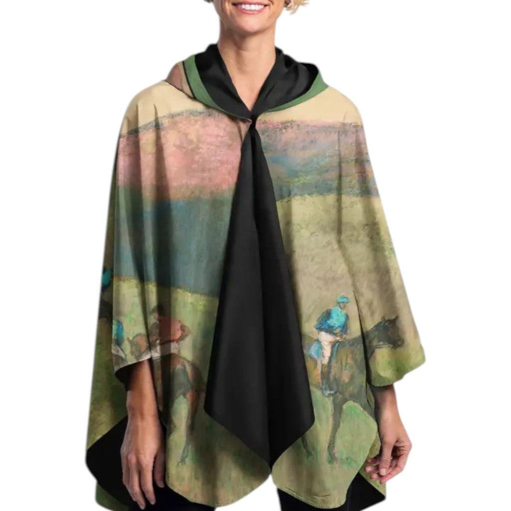 Person wearing a colorful poncho with a scenic design on a white background