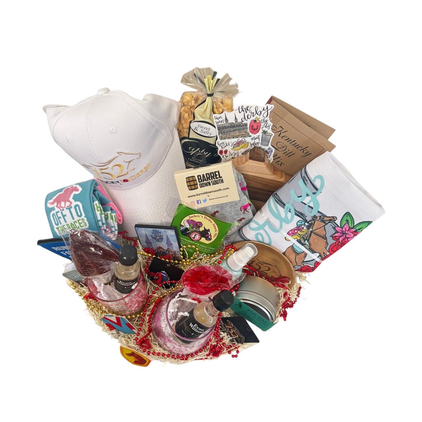 Overhead view of a round Derby 152 gift basket filled to the brim with cap, caramel corn, socks, candle, and more.