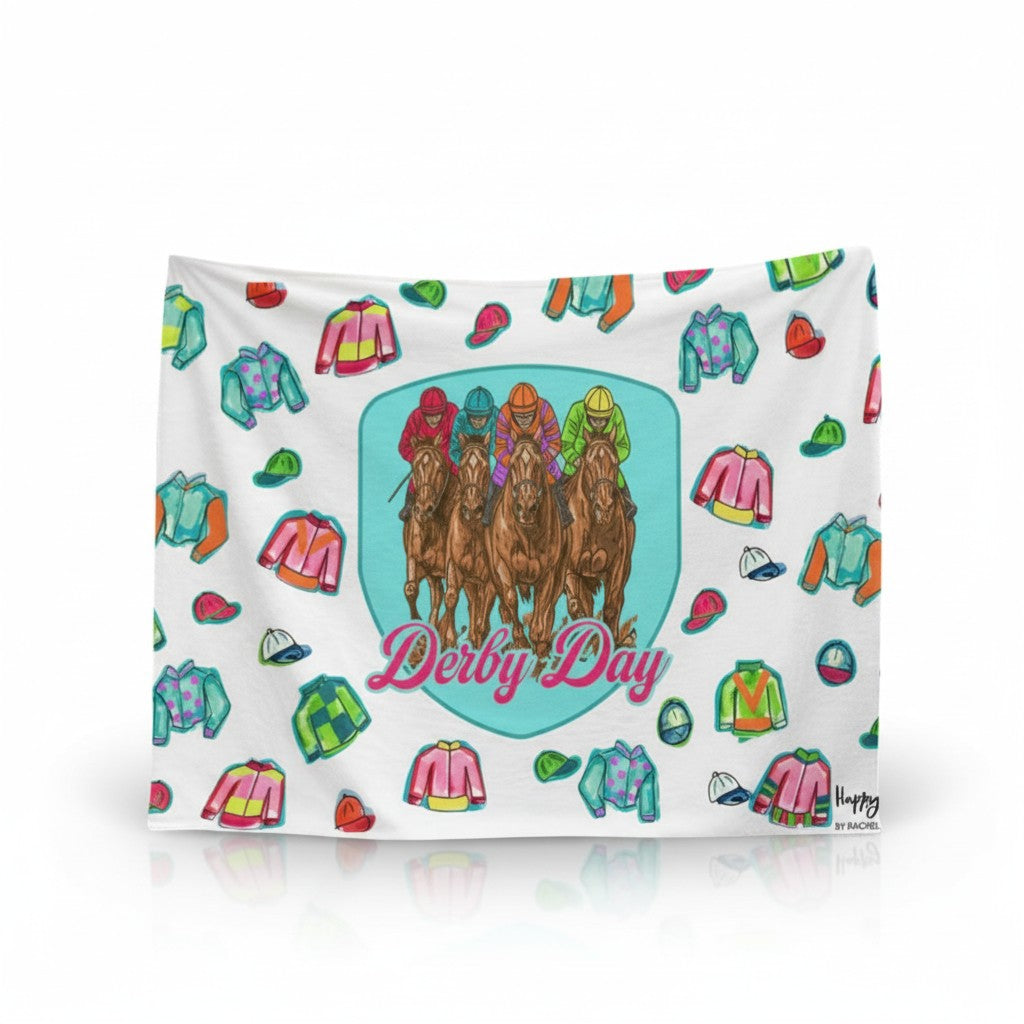 Soft white 50x80 fleece blanket featuring a central blue emblem with galloping horses and colorful jockey silks by Happy by Rachel.