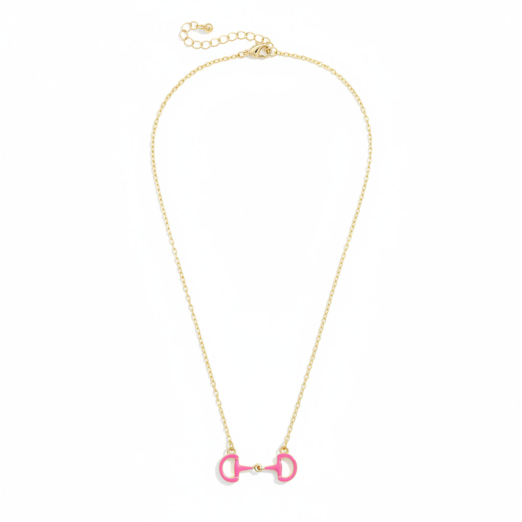 A close-up detail shot of the Pink Eclipse Enamel Horsebit Necklace pendant on its gold-tone chain.