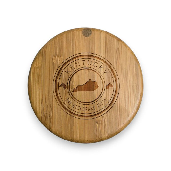 A close-up of the salt box lid showing the detailed engraving of "Kentucky," "The Bluegrass State," and the state silhouette.