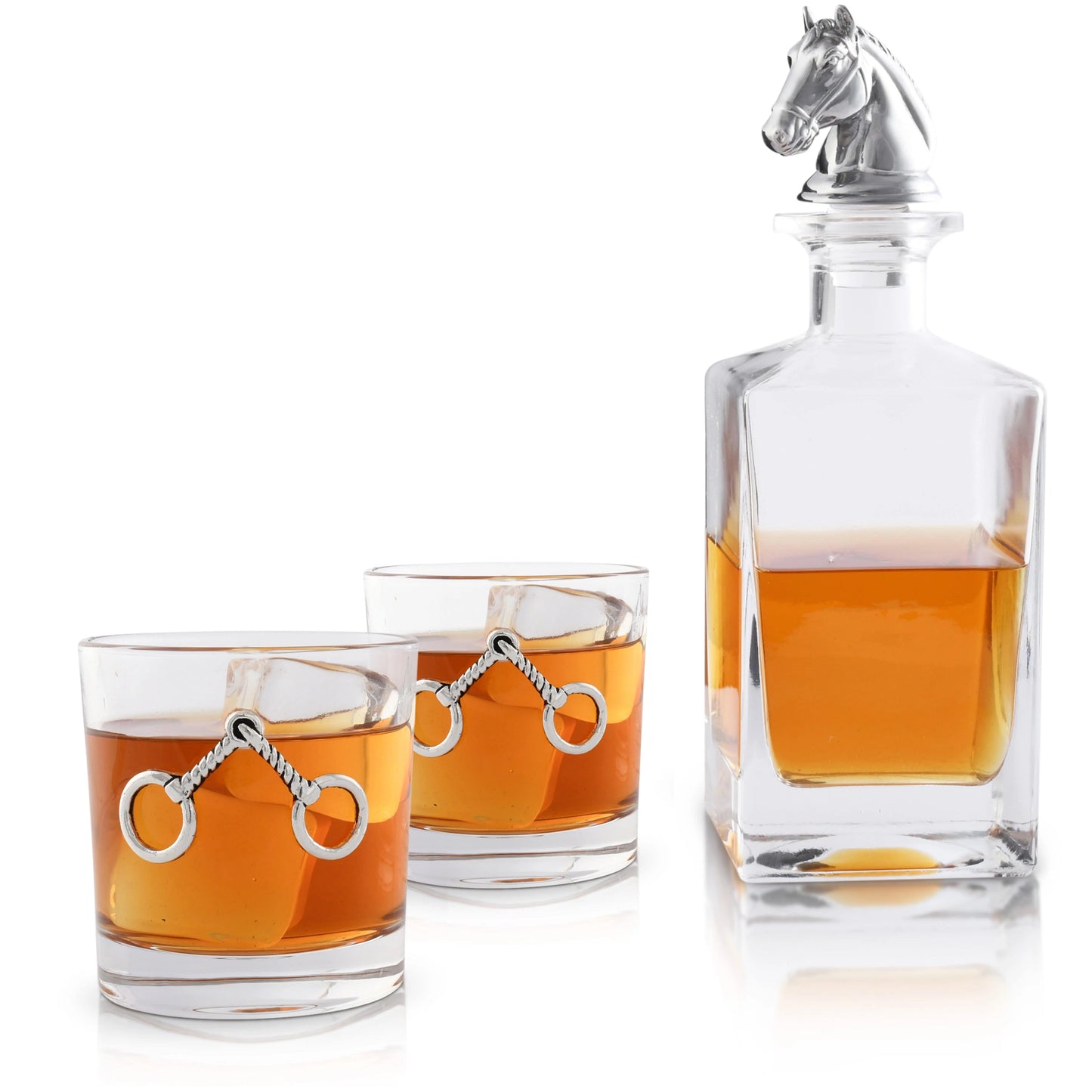 Glass decanter and glasses with horse stirrup design filled with amber liquid on a white background