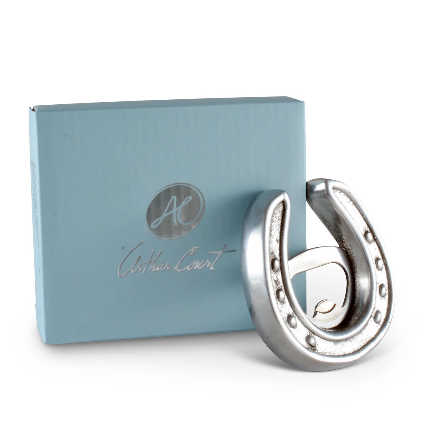 Silver horseshoe-shaped earring next to a blue box with 'Arthur Court' branding on a white background