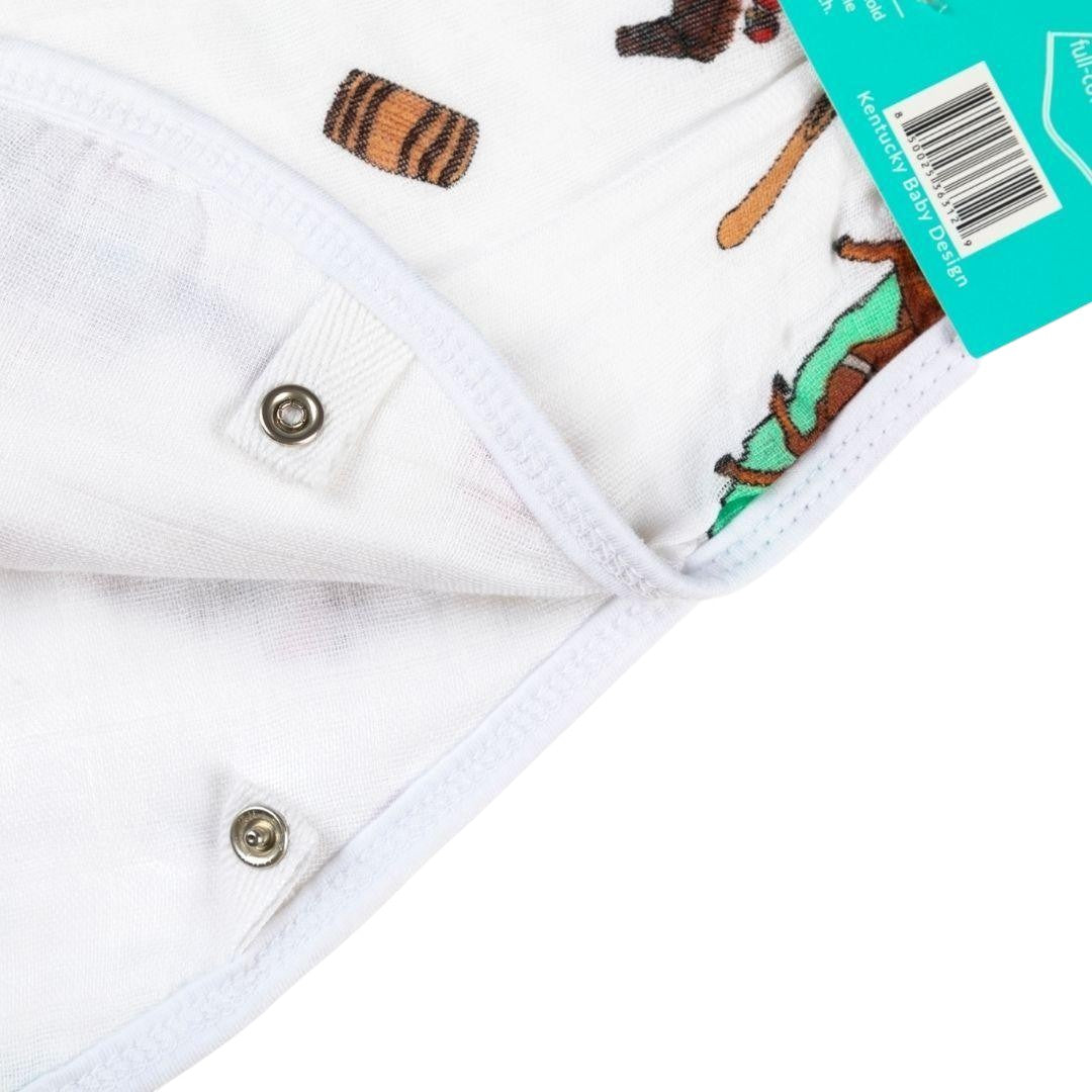 Close-up of a baby blanket with animal patterns and a brand label.