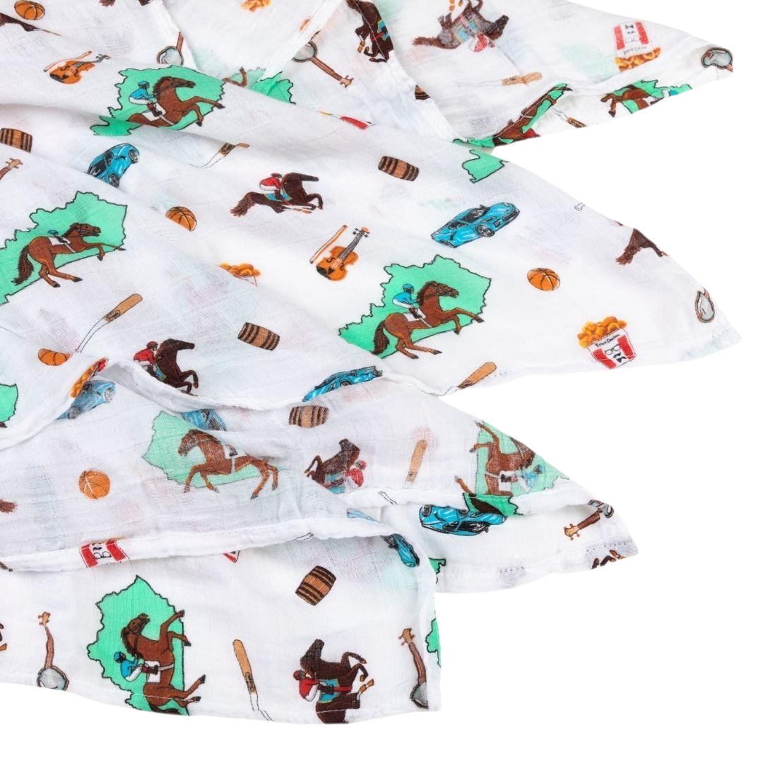 Fabric with cowboy-themed pattern featuring horses, boots, and hats on a white background