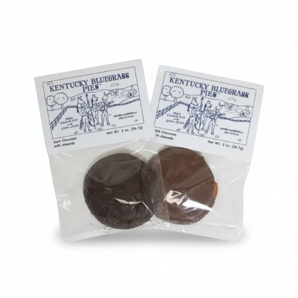 The two variants of Kentucky Bluegrass Pies, Milk Chocolate and Dark Chocolate, shown side-by-side in their packaging.