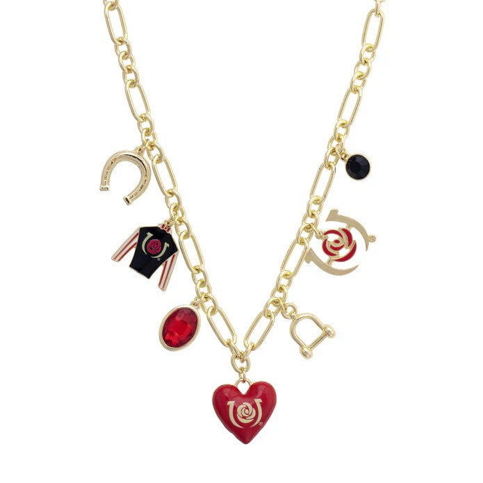 Close-up detail of the central red enamel heart charm and other equestrian-themed charms on the gold necklace.
