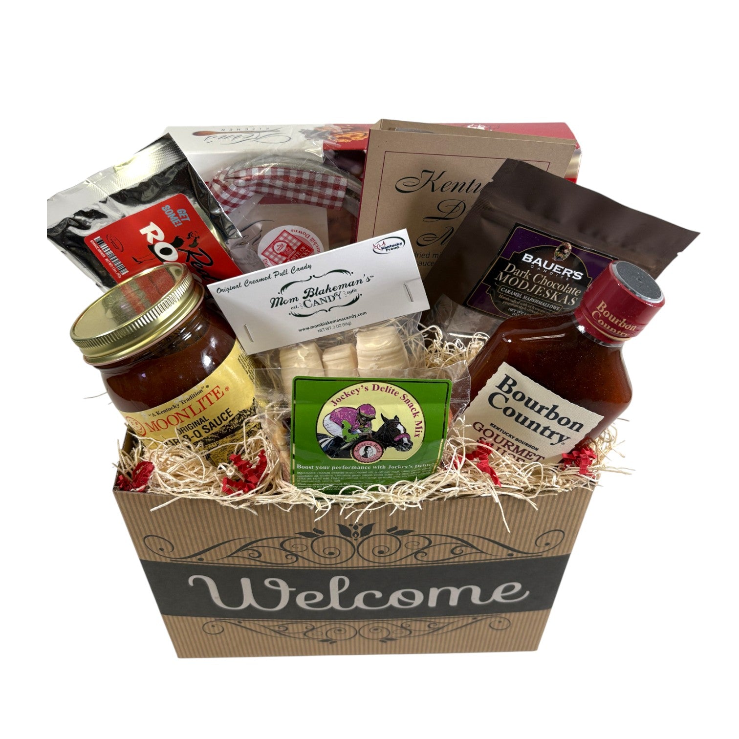 A top-down view of all items in the Welcome Gift Box, including Moonlite BBQ sauce, Bourbon Country sauce, and snacks.