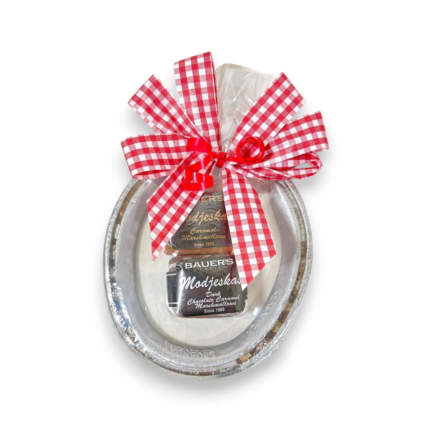 Authentic Churchill Downs horseshoe topped with a two-piece box of Bauer's Candies Modjeskas, tied with a gingham bow on a white background.