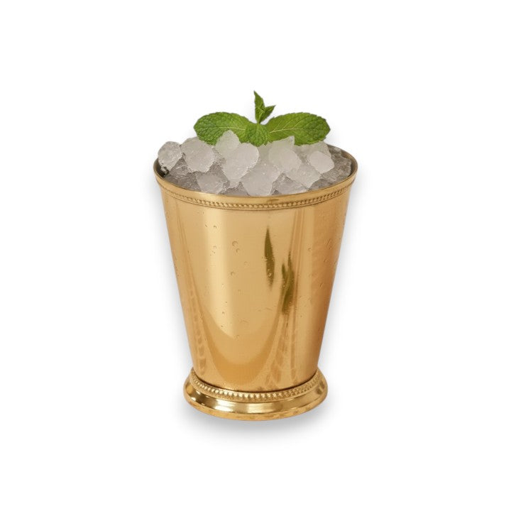 A close-up studio shot of the 12 oz gold stainless steel julep cup filled to the brim with crushed ice and garnished with a fresh sprig of mint, showcasing its reflective finish.