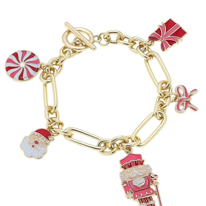 The Christmas Cheer charm bracelet with red, pink, and white enamel holiday icons.