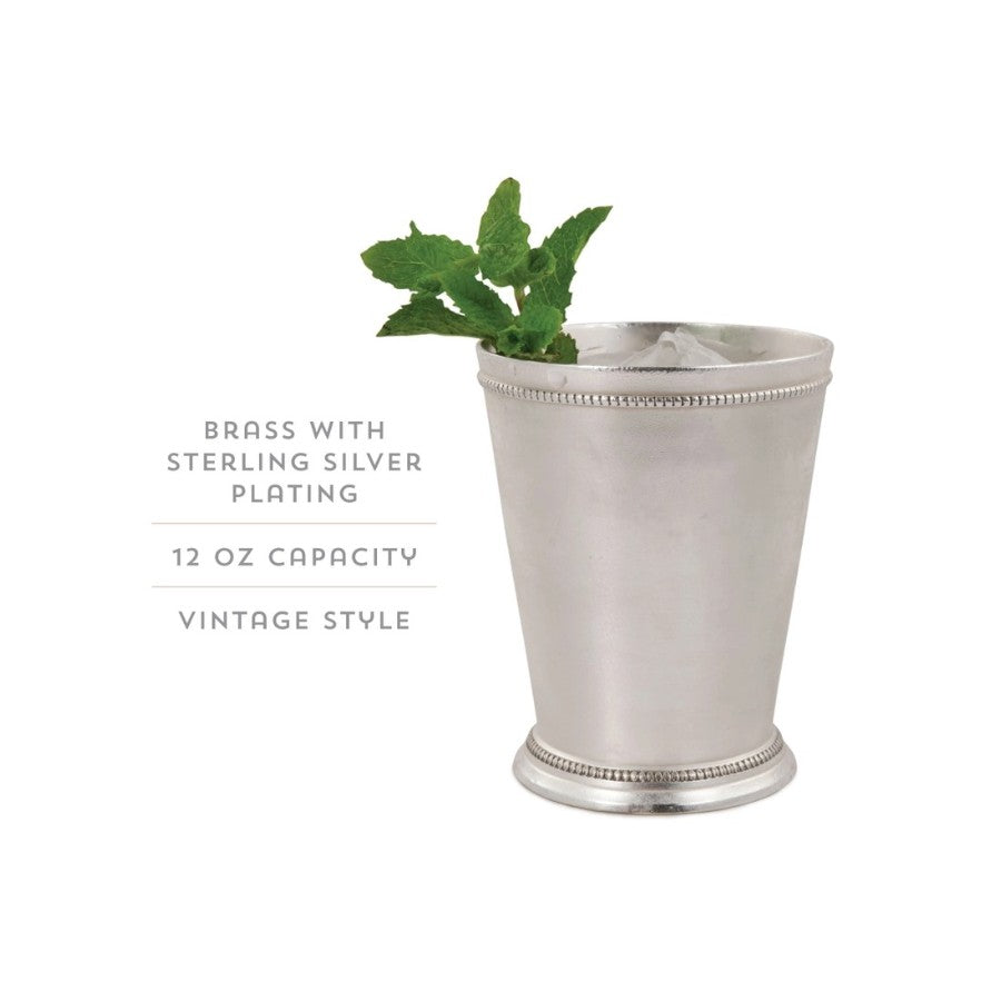 The vintage mint julep cup, frosted with condensation and filled with a classic mint julep cocktail, garnished with a fresh mint sprig.