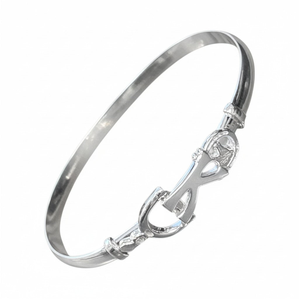 Silver bracelet with a horse bit design on a white background