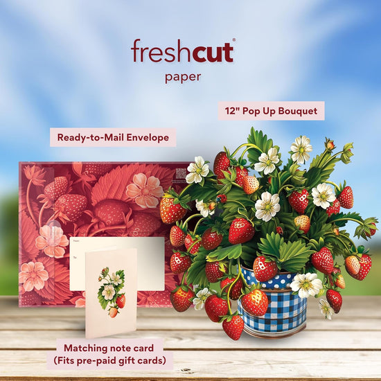 Fresh cut paper product with strawberry-themed items on a wooden surface