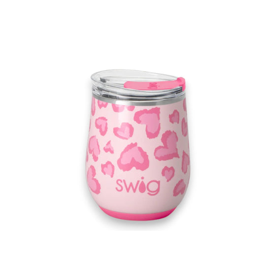 Pink tumbler with heart pattern and 'swig' branding on a white background