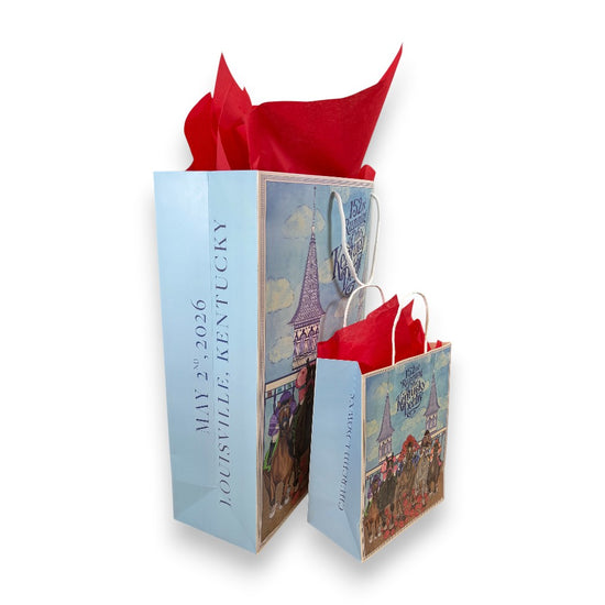 A side angle view of the large and small Kentucky Derby gift bags, revealing the vertical side panel text that reads 'MAY 2, 2026', 'LOUISVILLE, KENTUCKY', and 'CHURCHILL DOWNS'.