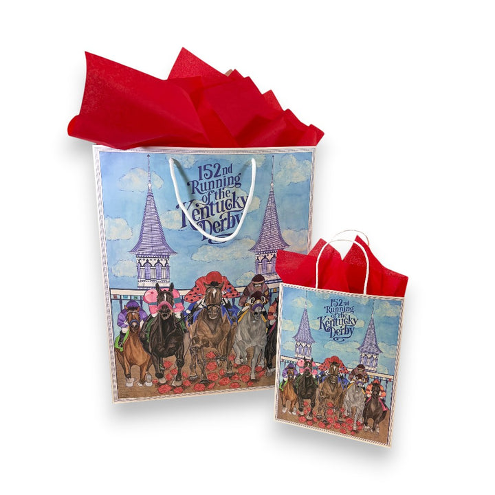 Two light blue 152nd Kentucky Derby gift bags, one large and one small, beautifully presented with vibrant red tissue paper and featuring commemorative horse racing artwork.