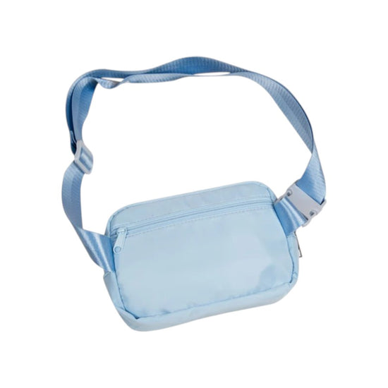 The back of the light blue polyester belt bag, showing the zippered back compartment and the adjustable strap.