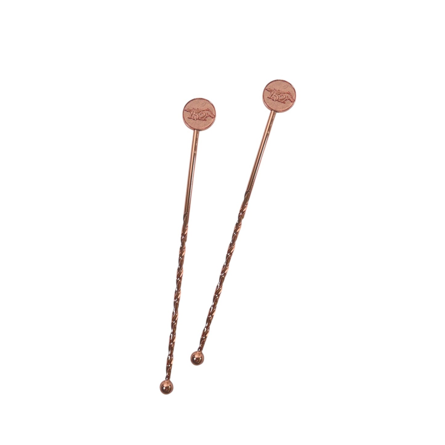 Two elegant copper-plated cocktail stirrers for the 152nd Kentucky Derby resting on a crisp white surface, showcasing their twisted metal shafts and embossed horse logo tops.