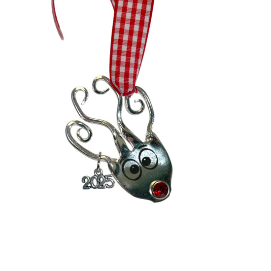 Detail shot of the small, engraved 2025 year charm on the reindeer ornament.
