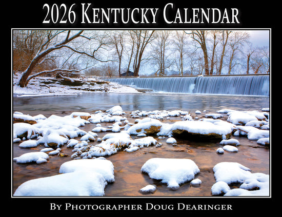 The cover of the 2026 Kentucky Calendar by Doug Dearinger, showing a snowy river scene.