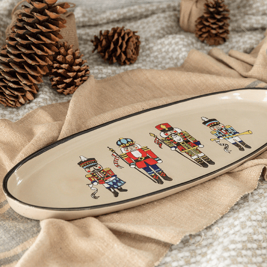 Nutcracker Antipasto Tray featuring four Nutcracker soldiers in festive colors on a stoneware platter, perfect for serving appetizers during the holidays.