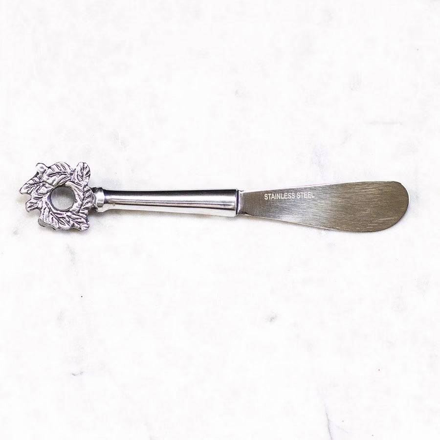 stainless steel cheese spreader with christmas wreath at the end of the handle
