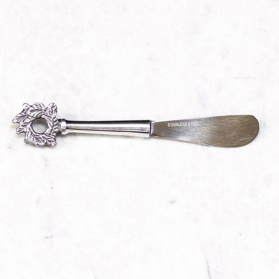 stainless steel cheese spreader with christmas wreath at the end of the handle