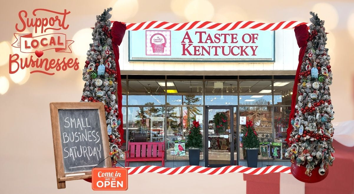 Storefront with 'A Taste of Kentucky' sign, decorated trees, and a chalkboard sign for Small Business Saturday.