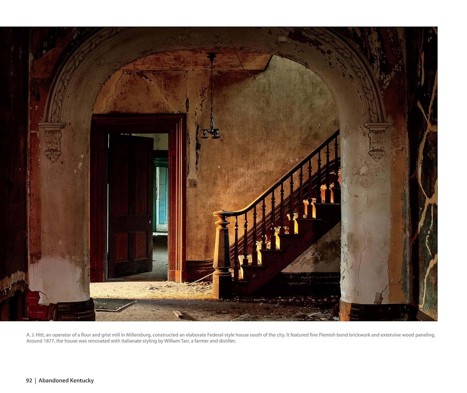 An interior page from the "Abandoned Kentucky" book, featuring a photo of a grand, decaying staircase.