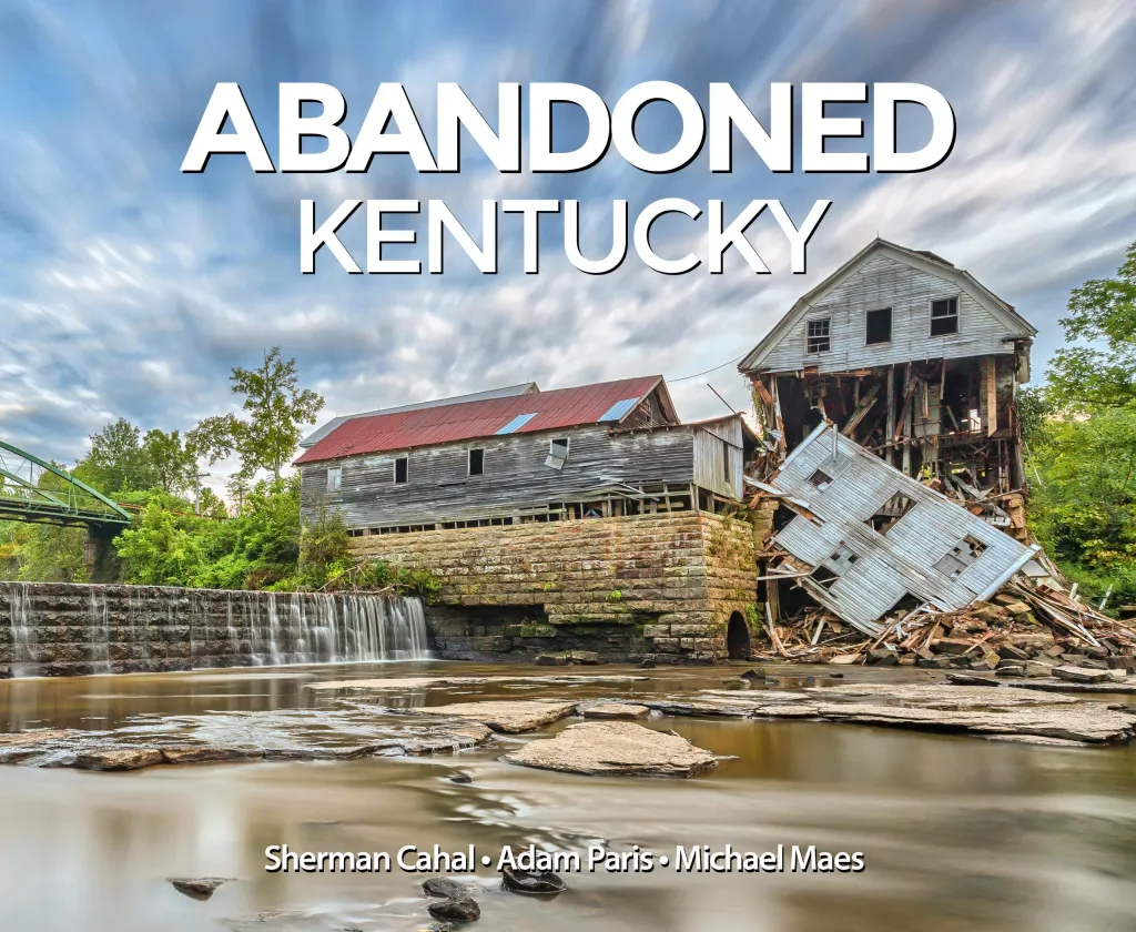 The front cover of the hardcover book "Abandoned Kentucky," showing a dramatic photo of a collapsed mill by a waterfall.