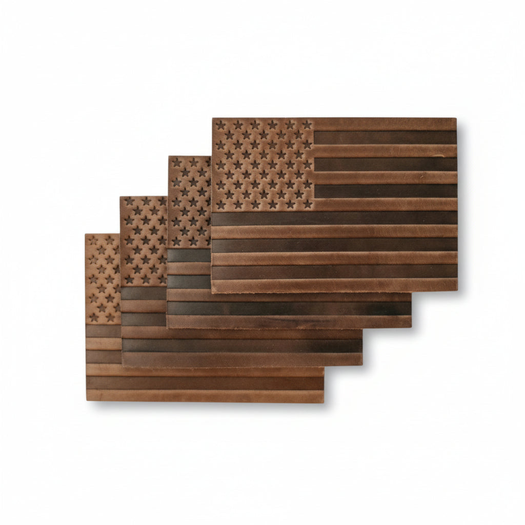 A set of four brown Horween leather coasters, each featuring a debossed American flag design, displayed together.