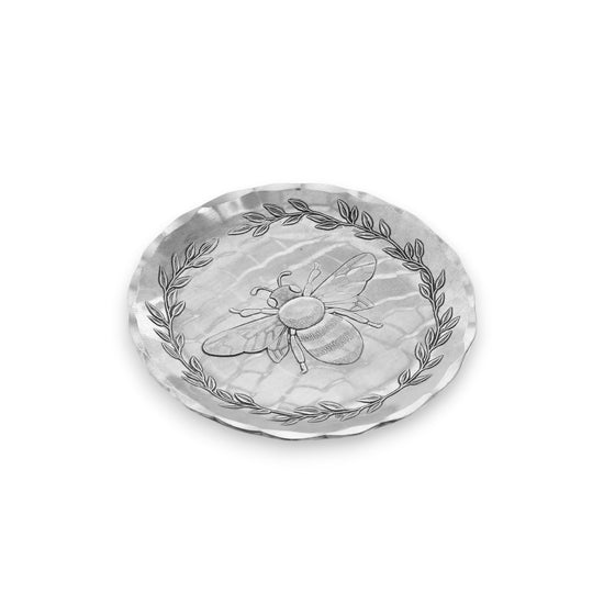 An angled close-up of the Honey Bee coaster, highlighting the handcrafted texture of the aluminum.