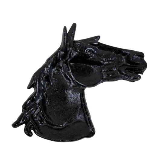 Black cast iron horse head decorative item on a white background