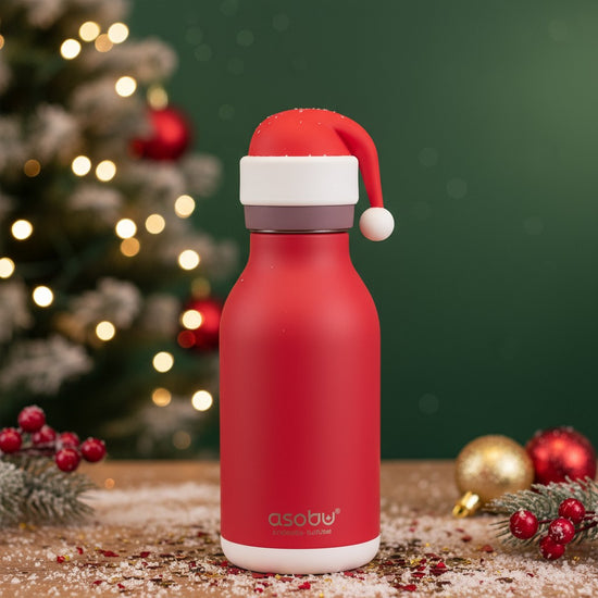 A lifestyle image showing the Santa Bestie Bottle next to Christmas cookies and decorations.