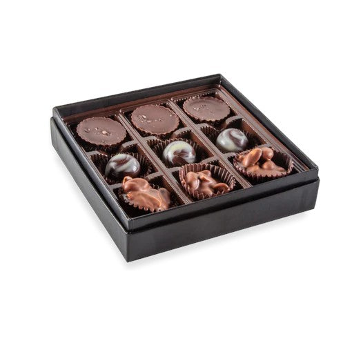 An open 9-piece box showing three varieties of handcrafted Kentucky chocolates.