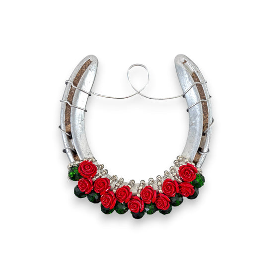  An authentic, track-worn horseshoe from Churchill Downs decorated with a lush garland of red roses and beads.