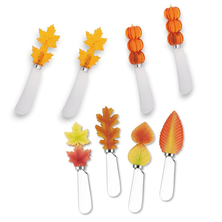 Set of eight cheese knives with leaf and pumpkin-shaped ends on a white background