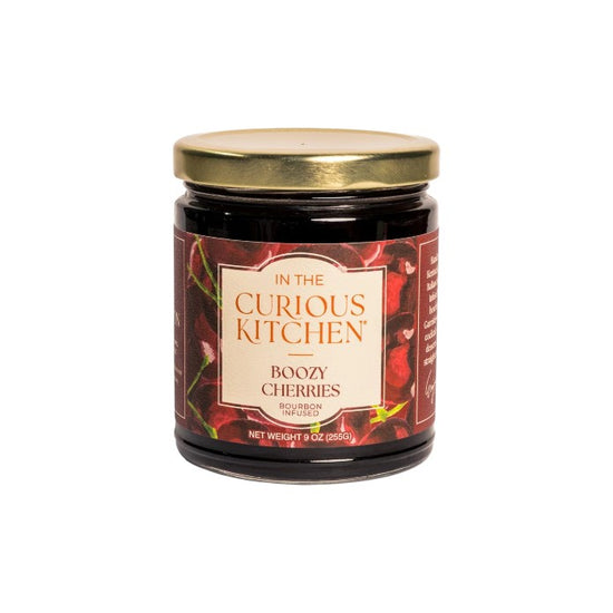 A jar of Boozy Cherries with a gold lid and dark label, highlighting the bourbon-infused cocktail cherries inside.