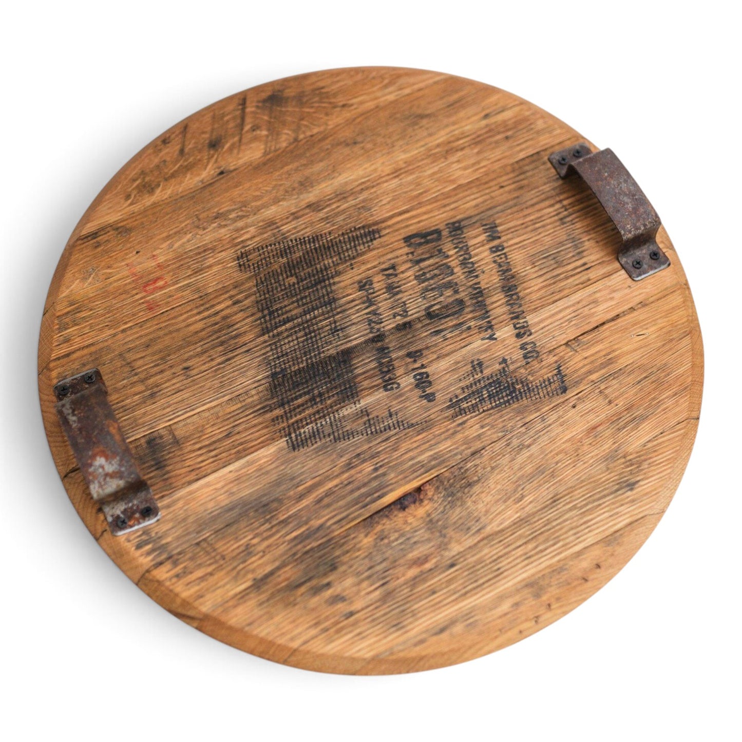 Top view of the round reclaimed bourbon barrel head serving tray with steel ring handles on each side.