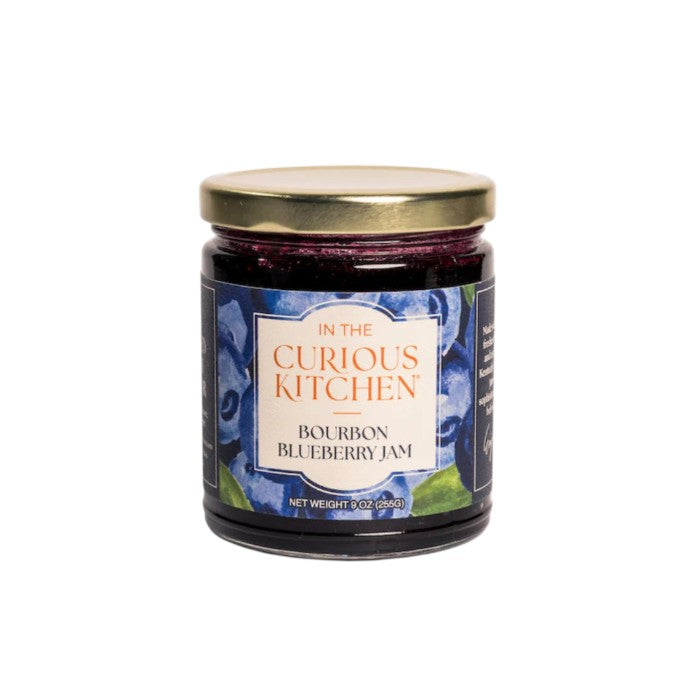  A 9 oz glass jar of Bourbon Blueberry Jam featuring a dark blue label with watercolor blueberry illustrations.