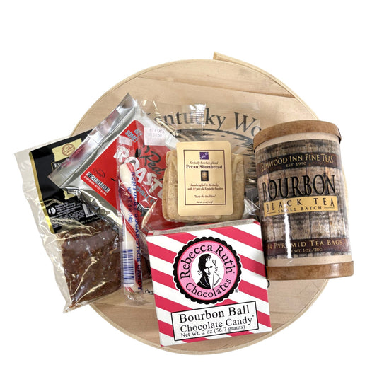 A top-down view of all items in the Let Them Eat Bourbon Gift Set, showing the cake, bourbon balls, shortbread, and coffee.