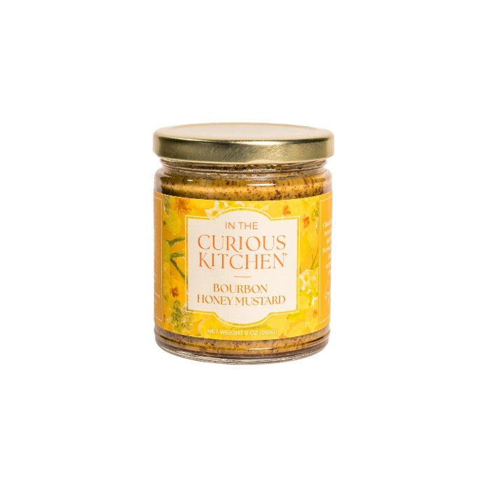 A glass jar of Bourbon Honey Mustard featuring a golden lid and a vibrant yellow floral label on a white background.